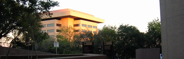 The sun sets on Texas State's JCK building.